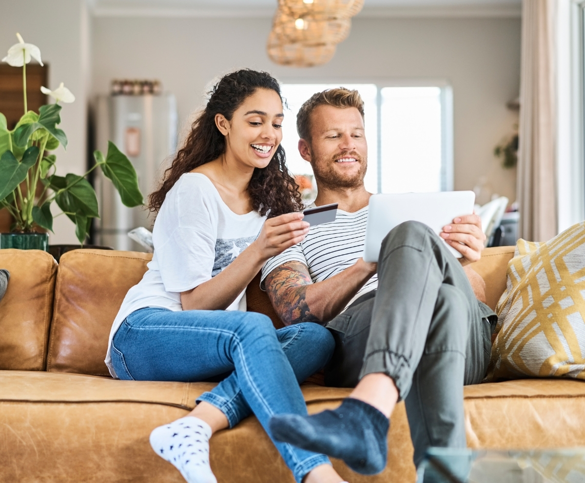 Man looking at credit card and phone