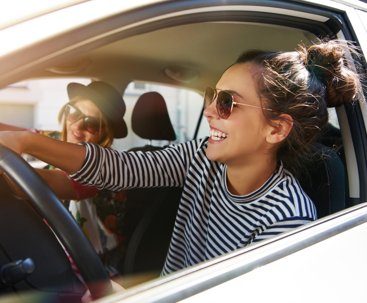 car dealer handing over key for new auto