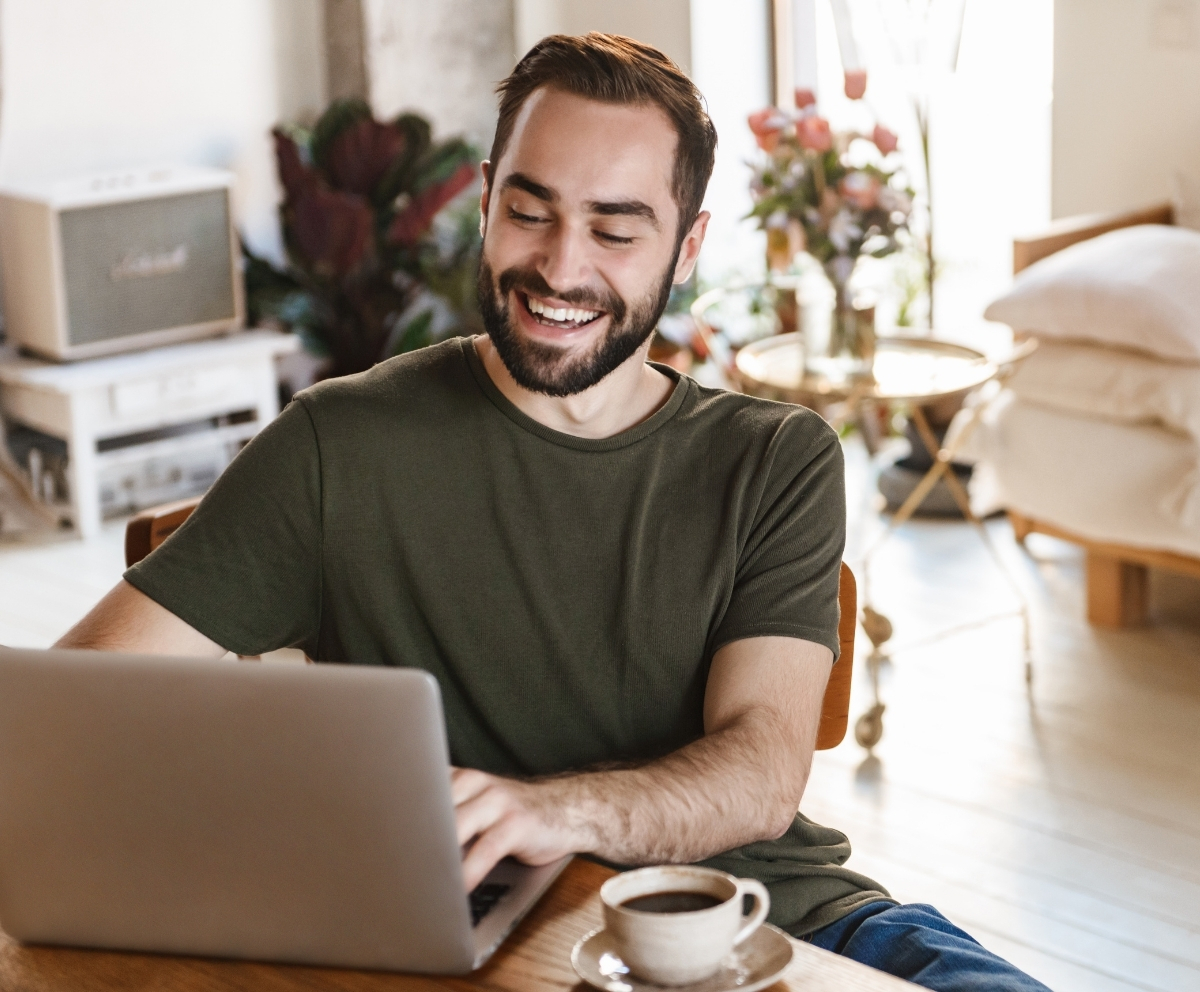 Man looking at credit card and phone